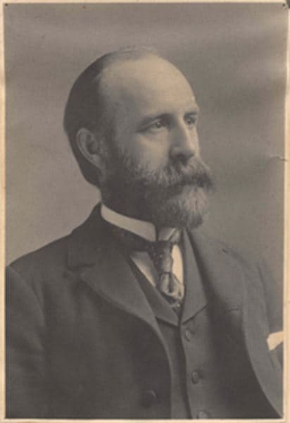 Sepia studio portrait of Dr. Jesse Walter Fewkes, bearded, in a suit and tie